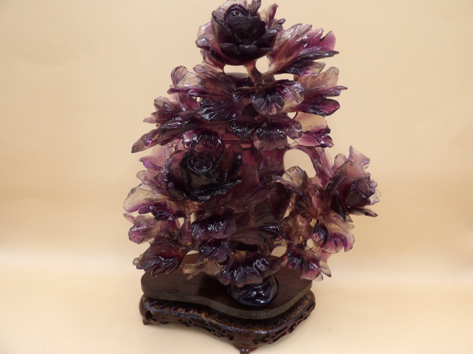 ornate Chinese carved amethyst lidded vase with multiple raised flowers on custom wood base: 9.2 inches height including wood base. We will inhouse ship items to you very affordable and efficient. Select self-arrange shipping.