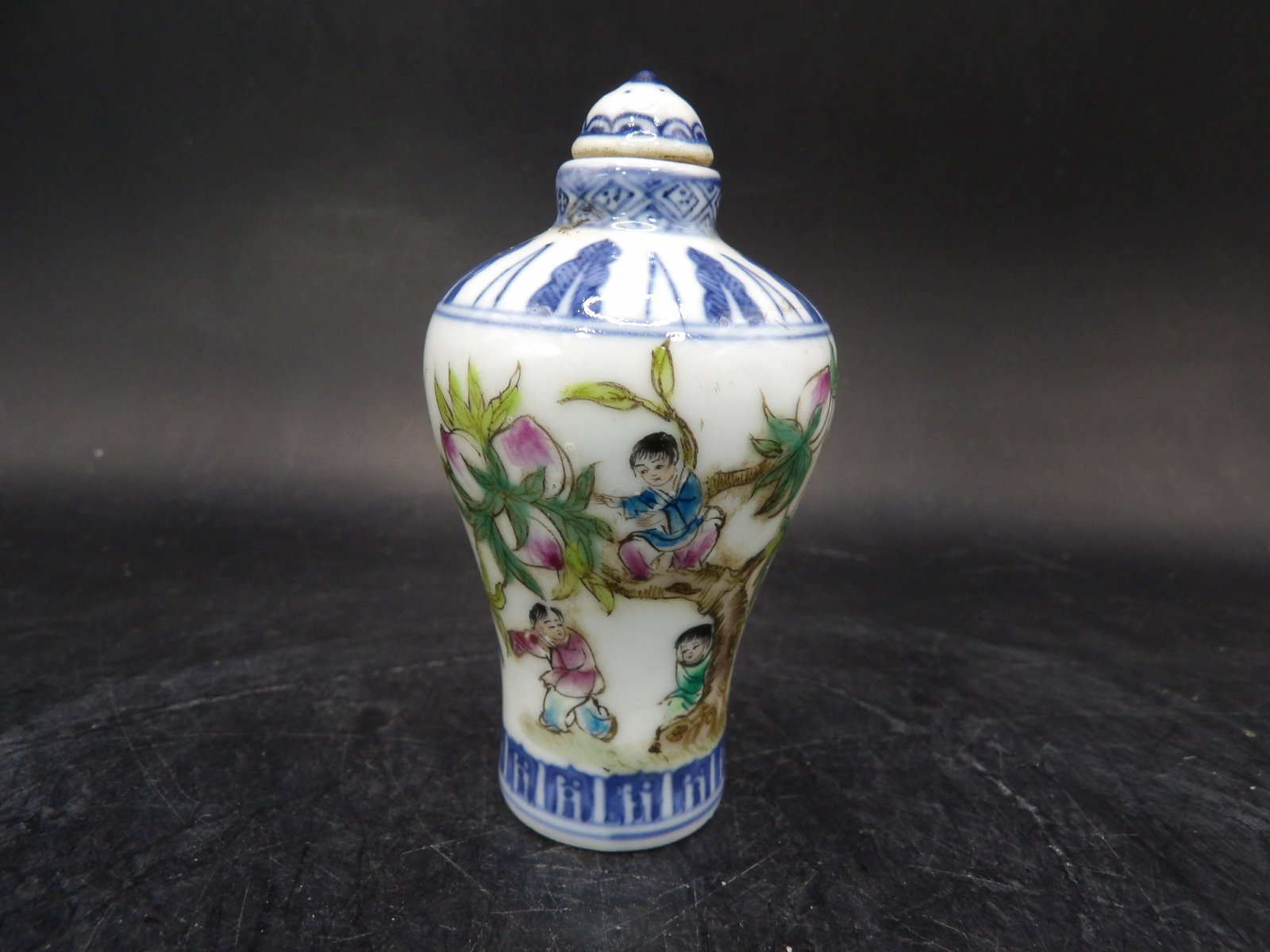 Chinese porcelain hand painted snuff bottle with children and peach tree signed: 2.9 inches height.