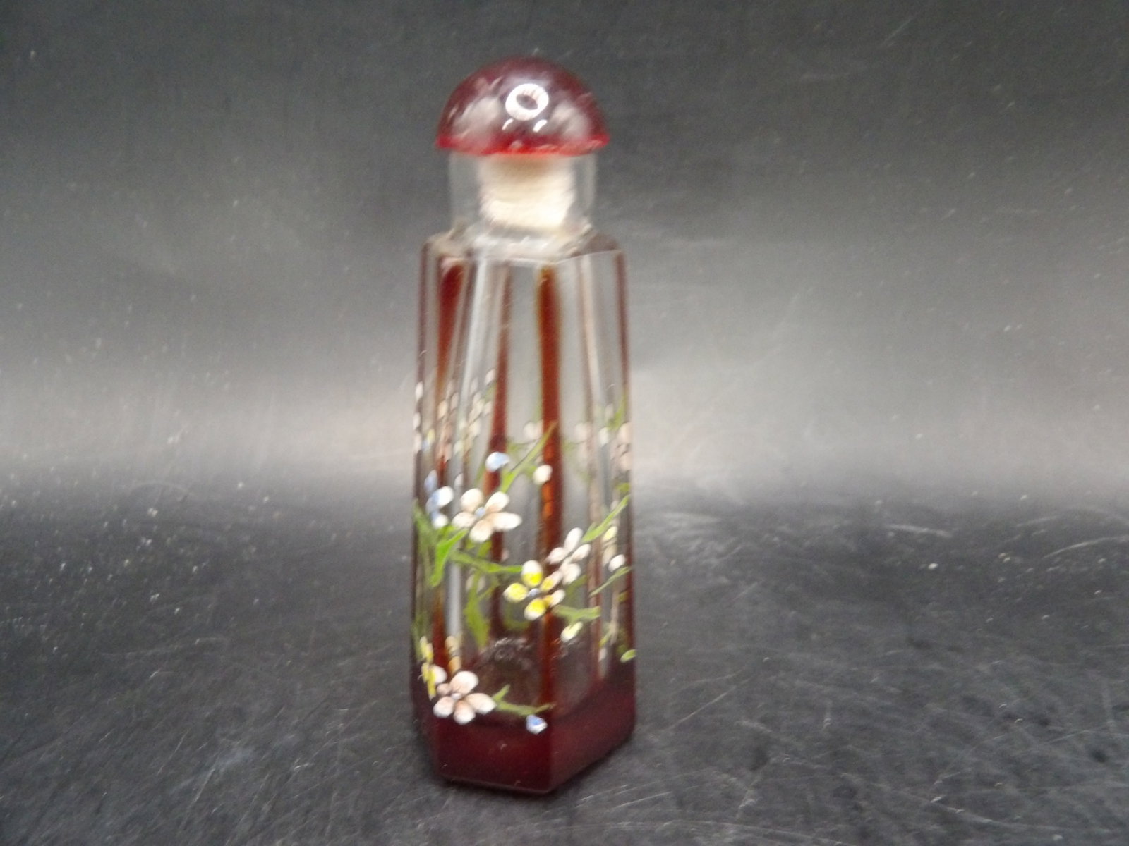 Chinese peking glass hexagon shaped snuff bottle with slightly raised floral motif: 3.1 inches height.