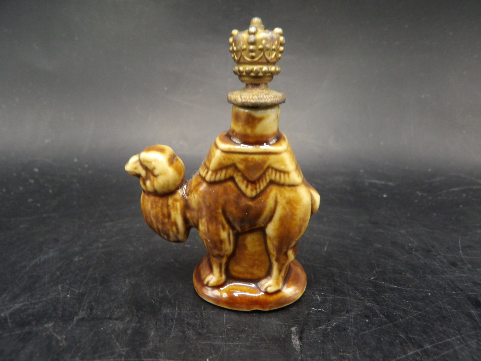 1930s Germany ceramic camel shaped perfume bottle with a crown stopper: 2.2 inches height.