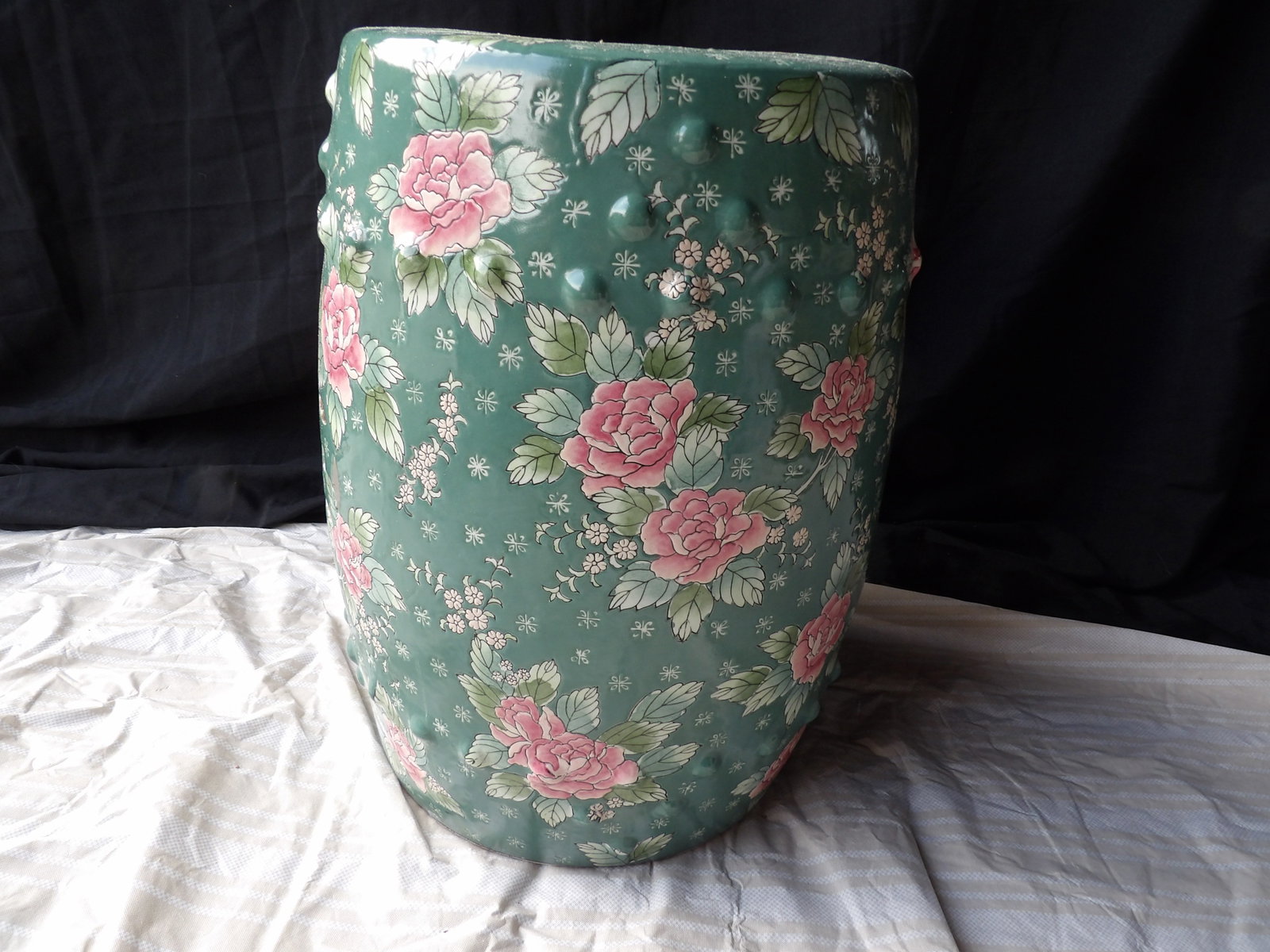 Chinese porcelain garden stool green background with rose motifs: 18 inches height.