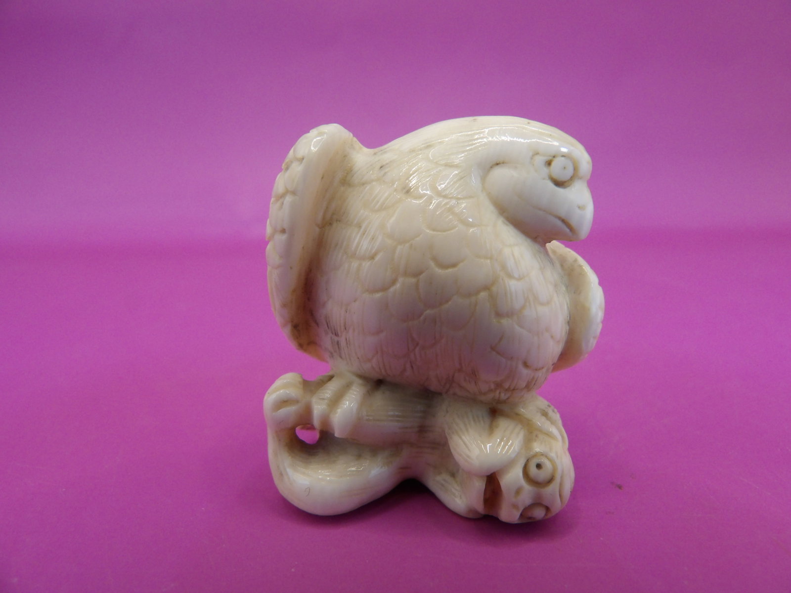 rare antique Japanese bone carved netsuke depicting a bird of prey on a coiled creature: 1.2 inches height. No international shipping. Signed on the bottom.