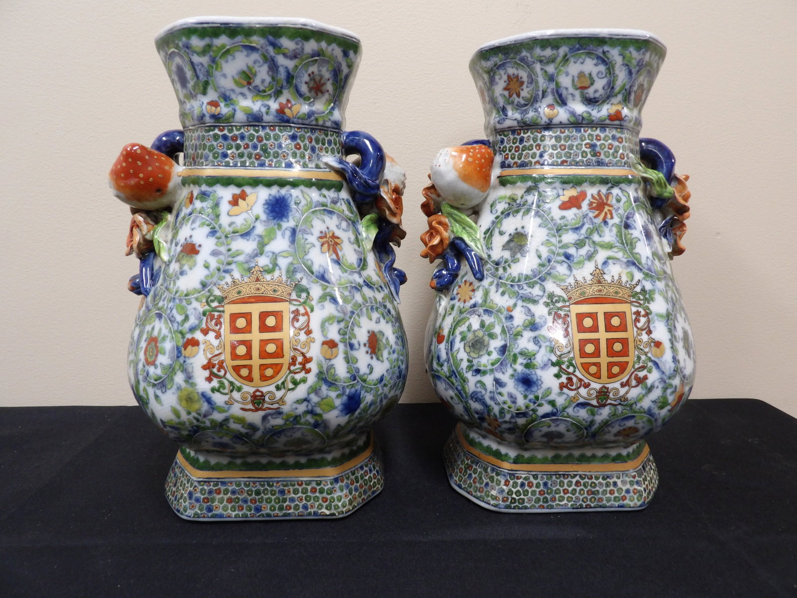 pair of ornate Chinese export porcelain vases with applied fruit and floral handles: 12 inches height.