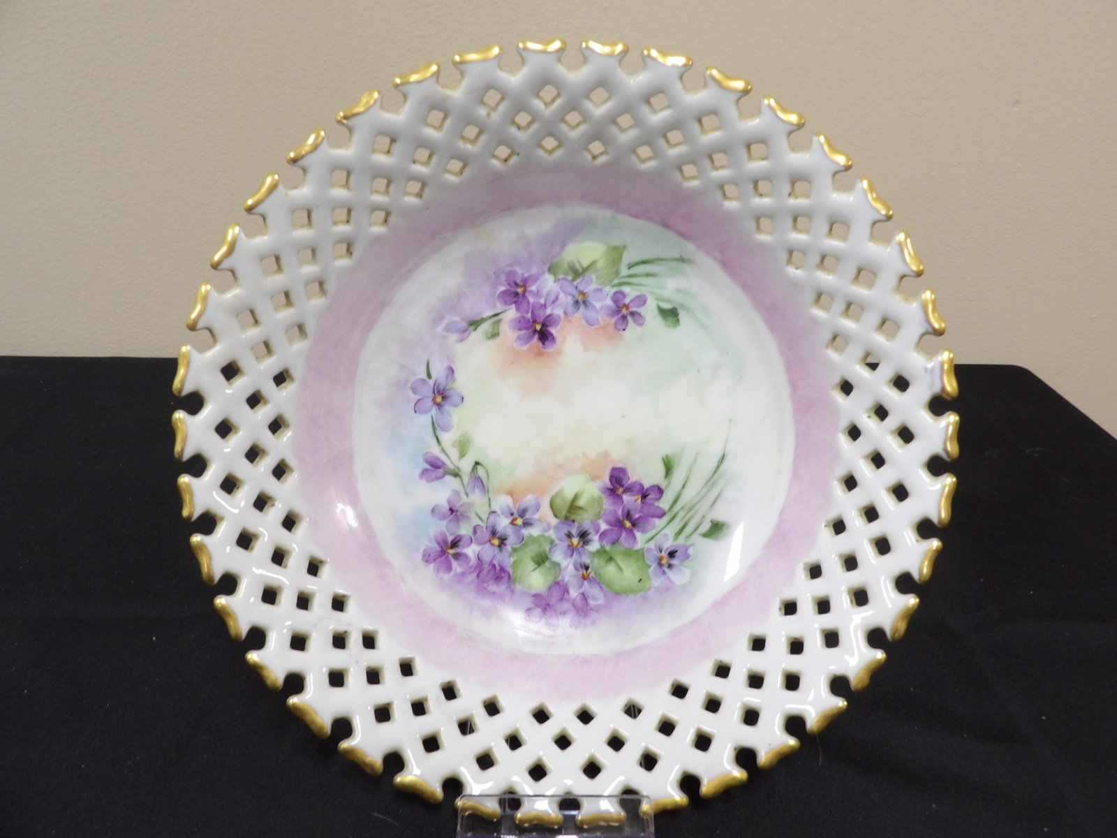 fine hand painted porcelain reticulated plate or shallow bowl with floral motif and gold trim: 9 inches diameter.