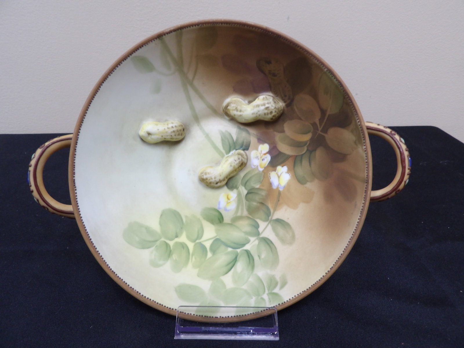 antique hand painted Japanese Nippon bowl with 3 raised peanut relief and handles: 8.7 inches length including handles. Bottom has protective pads.