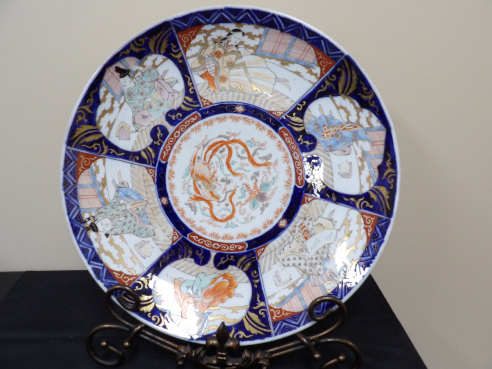 19th century antique Japanese Imari porcelain charger plate with figural and mythical creature motif: 18 inches diameter. Metal display base is not included. We will inhouse ship items to you very affordable and efficient. Select self-arrange shipping.