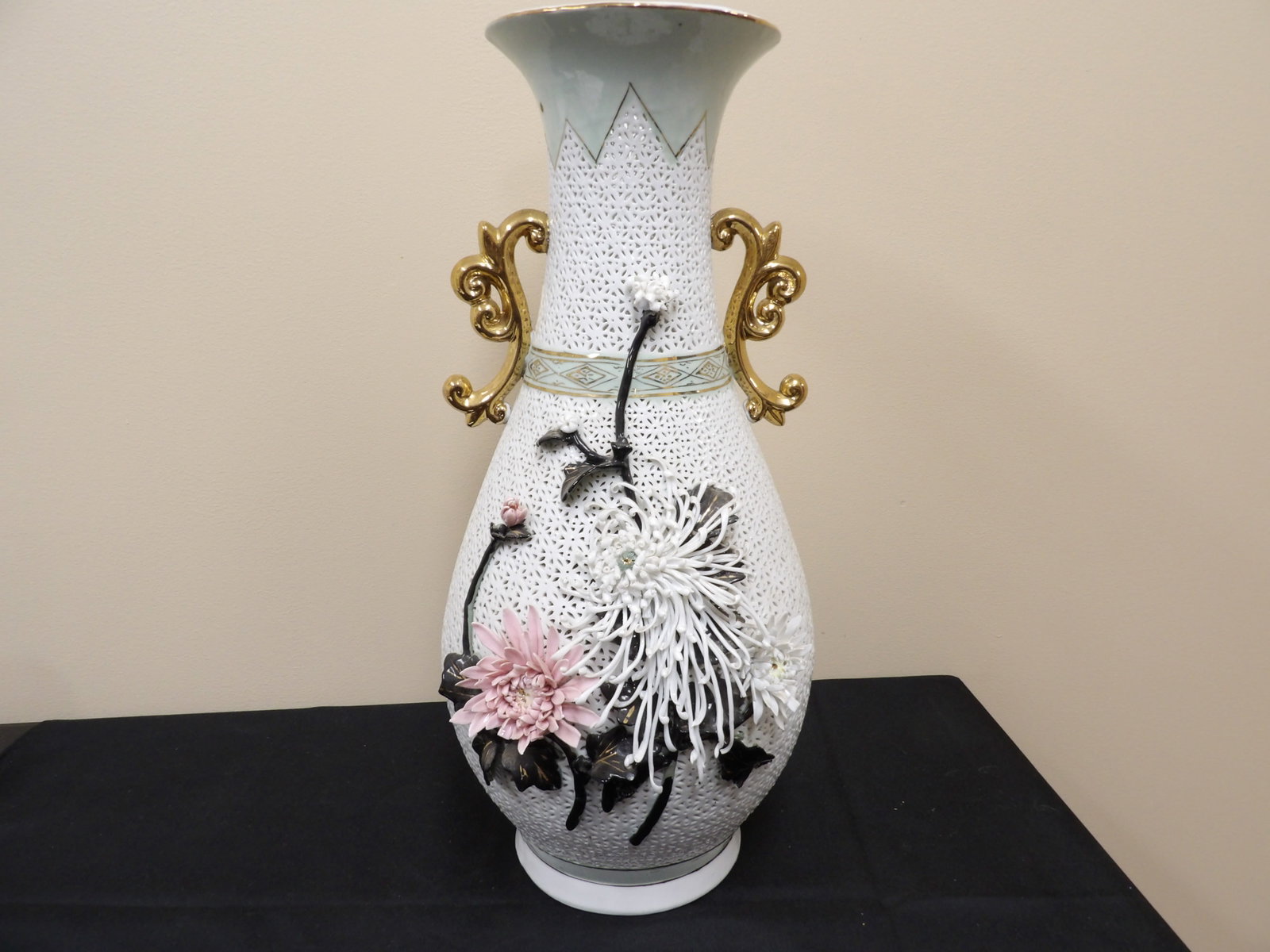 ornate Chinese reticulated porcelain vase with applied flowers and gilded handles: 20 inches height. This vase seems to have 2 bottoms. Shallow bottom is only about 11 inches from vase opening. 2nd bottom has a hole.