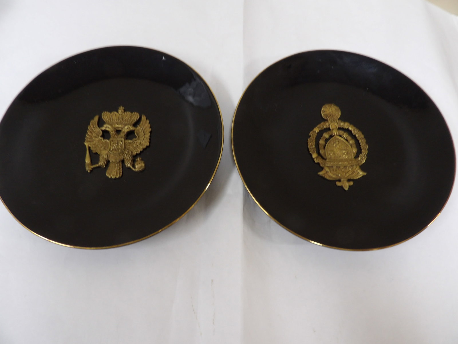 pair of Chinese export porcelain black glazed with raised imperial Russian emblem: 10.3 inches diameter. One with raised coat of arms emblem. The other one has raised imperial Russian double-headed eagle emblem. We will inhouse ship items to you very affordable and efficient. Select
