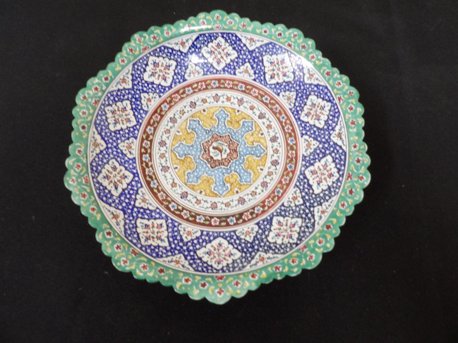 Persian or Turkey Minakari art plate with intricate floral and geometric motifs: 7.5 inches diameter. Back has hanging holes.