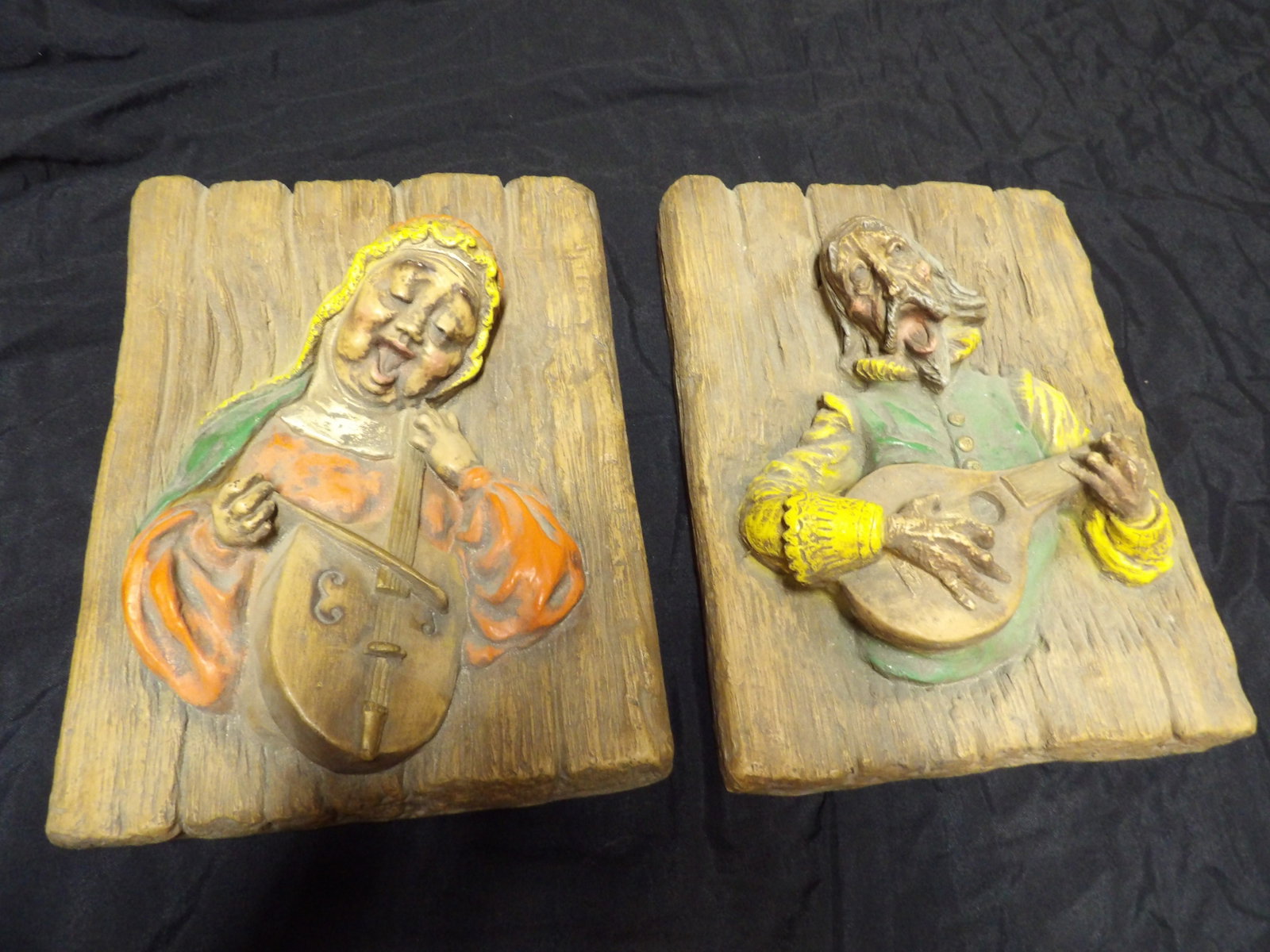 pair of mid century raised painted musician motif hanging plaques: 11.5 inches width.