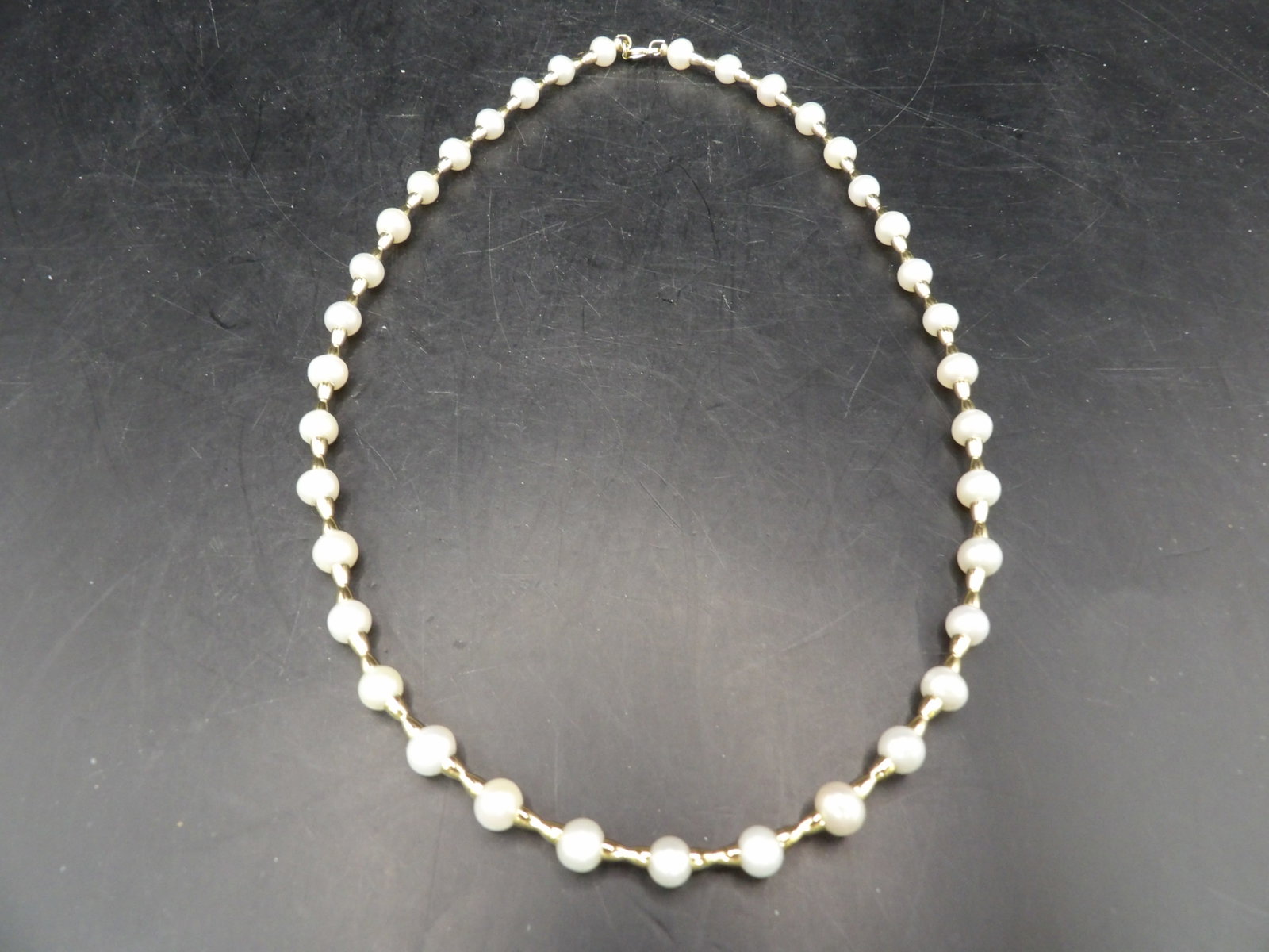 14k gold connecting bar and pearl necklace marked 14k: Clasp and all connecting bars are 14k. Pearl size is approx. 5mm. 16 inches length. 11.8 grams. We will inhouse ship items to you very affordable and efficient. Select self-arrange shipping.