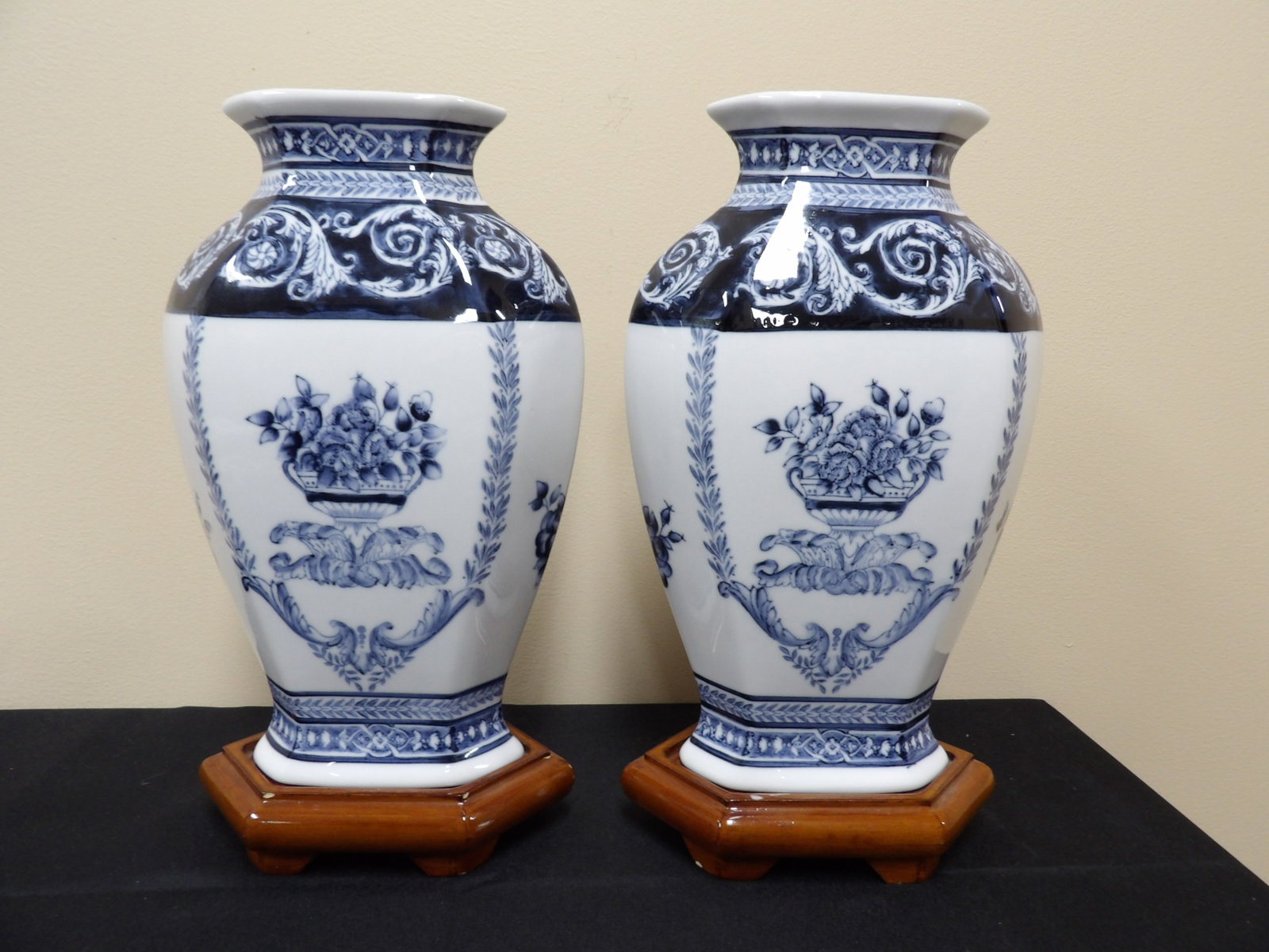 pair of Bombay Co. made in Chinese blue and white floral porcelain vases with wooden bases: 12 inches height not including wooden bases. We will inhouse ship items to you very affordable and efficient. Select self-arrange shipping.