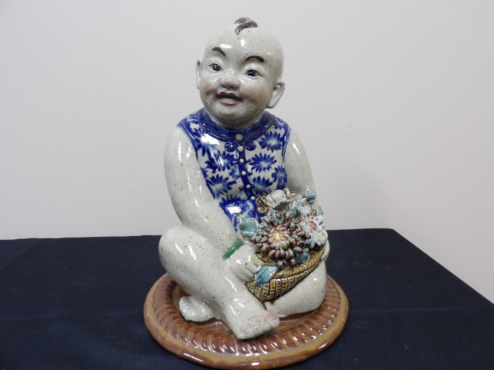 fine quality Chinese porcelain boy holding flowers statue signed: 11 inches height. We will inhouse ship items to you very affordable and efficient. Select self-arrange shipping.
