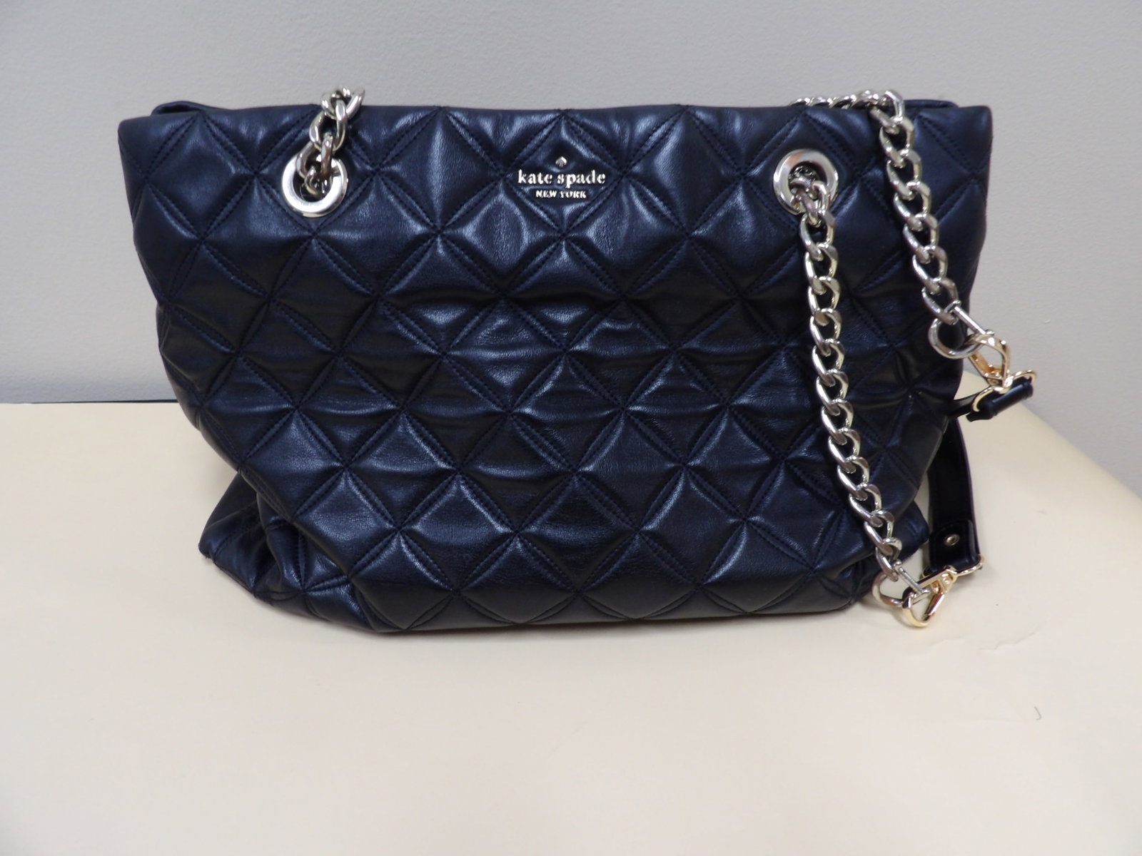 Kate Spade quilted leather shoulder bag: Approx size is 12 x 7.5 x 6 inches. With back pocket, 2 zipper pockets, 2 compartments plus small pockets.