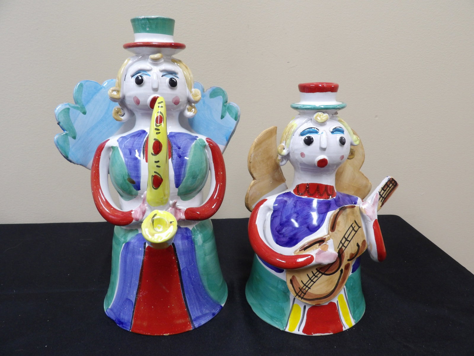 pair of De Simone Italian art pottery angel candle holders with musical instruments: Taller one is approx 11 inches height. We will inhouse ship items to you very affordable and efficient. Select self-arrange shipping.