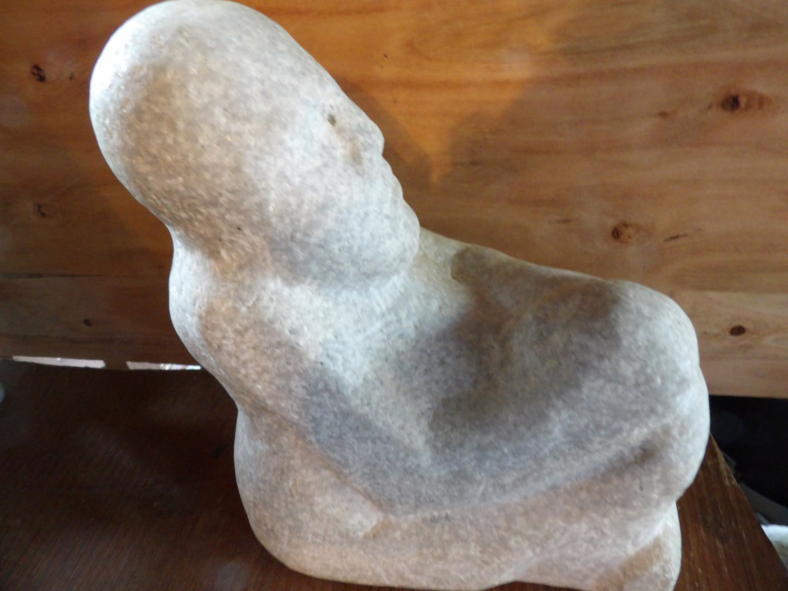 heavy stone sculpture of a seated abstract human figure: 15 inches height. Probably limestone.