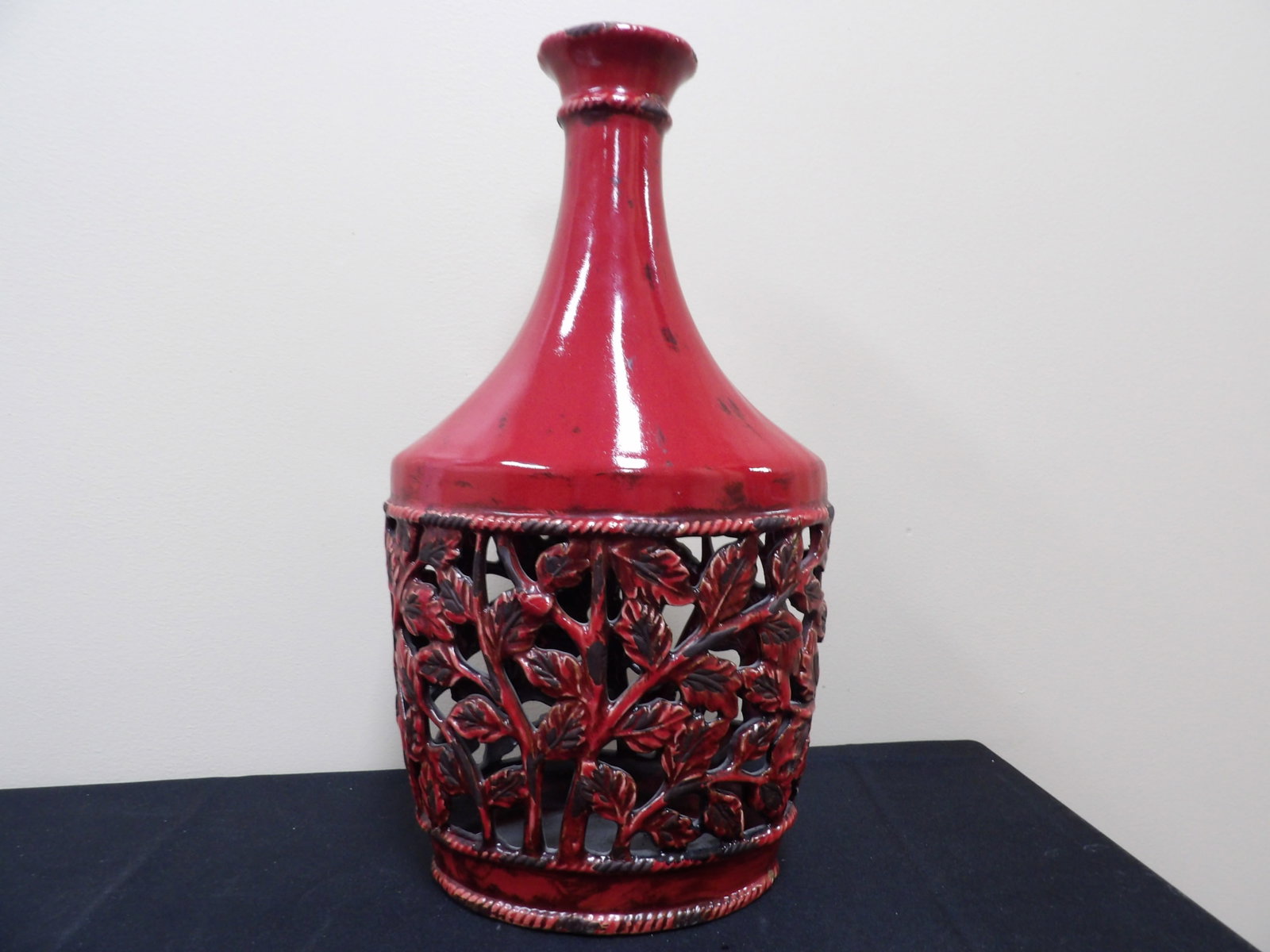 distressed red ceramic vase with reticulated floral deco: 18 inches height.