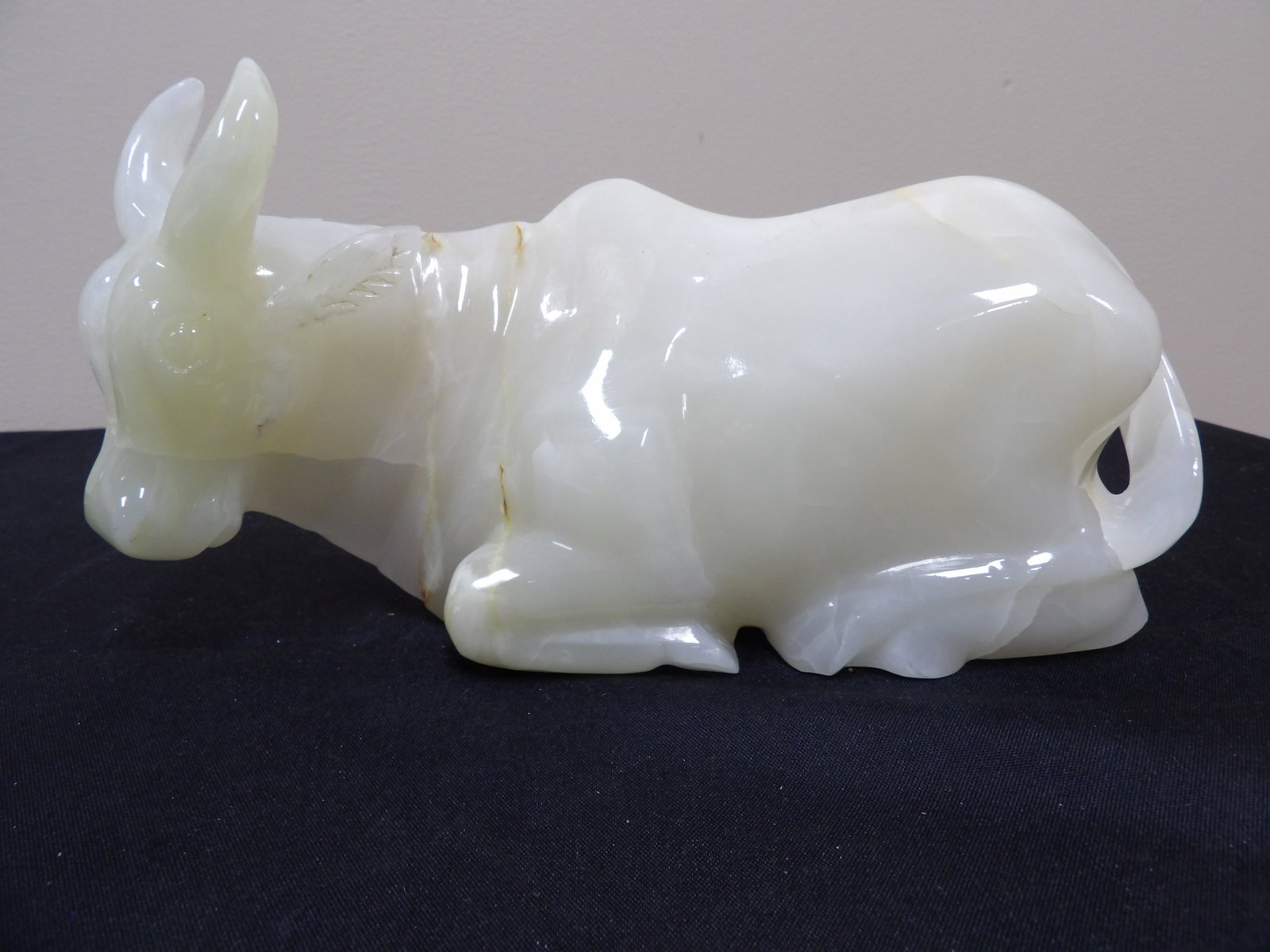 large Chinese carved stone figurine of a reclining bull: 6.7 lbs. 10 inches length.