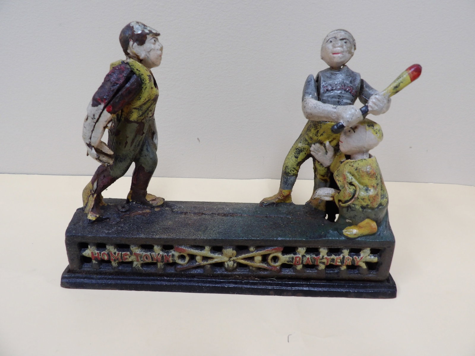 antique cast iron mechanical baseball coin bank with 3 figures: 9 inches length.