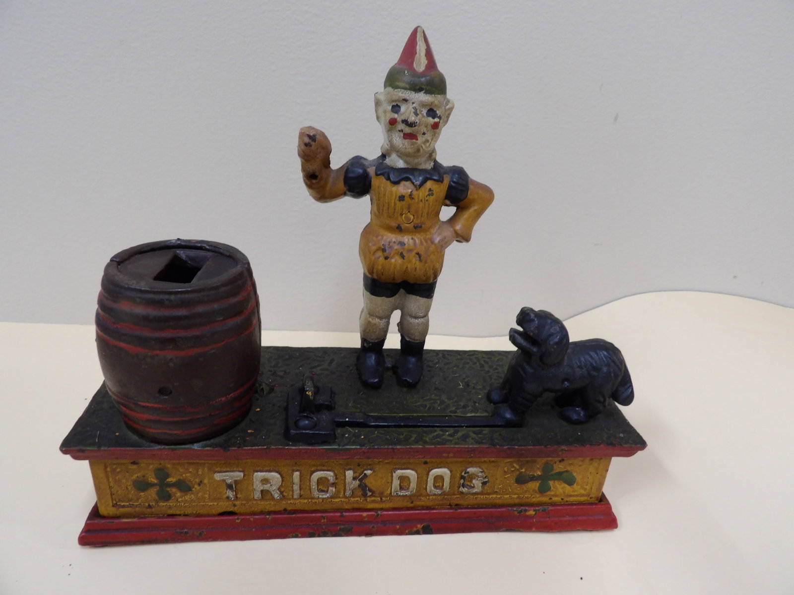Cast iron "Trick Dog" mechanical coin bank with clown and barrel: 7.7 inches length.