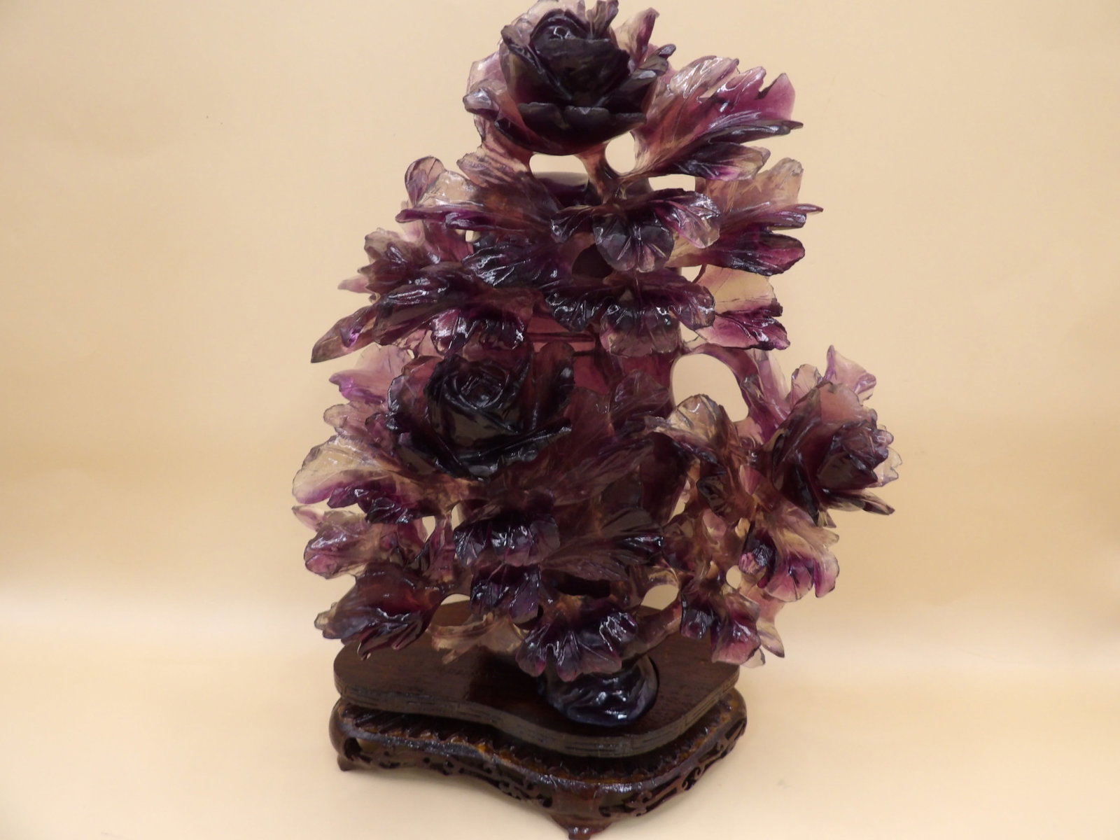 ornate Chinese carved amethyst lidded vase with multiple raised flowers on custom wood base: 9.2 inches height including wood base. We will inhouse ship items to you very affordable and efficient. Select self-arrange shipping.