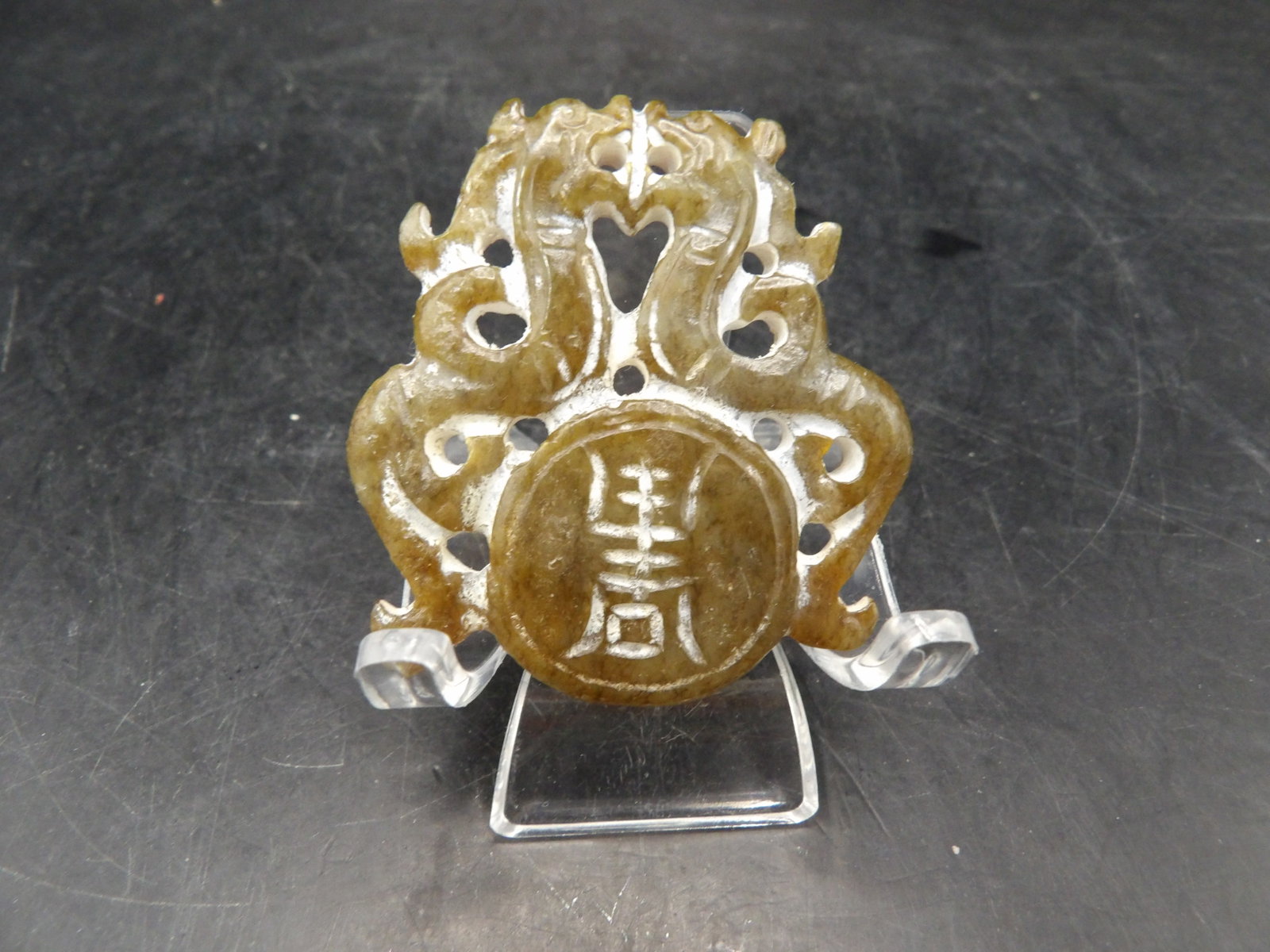 carved Chinese jade or stone pendant with double dragon motif: 1.8 inches height. 18 grams. We will inhouse ship items to you very affordable and efficient. Select self-arrange shipping.