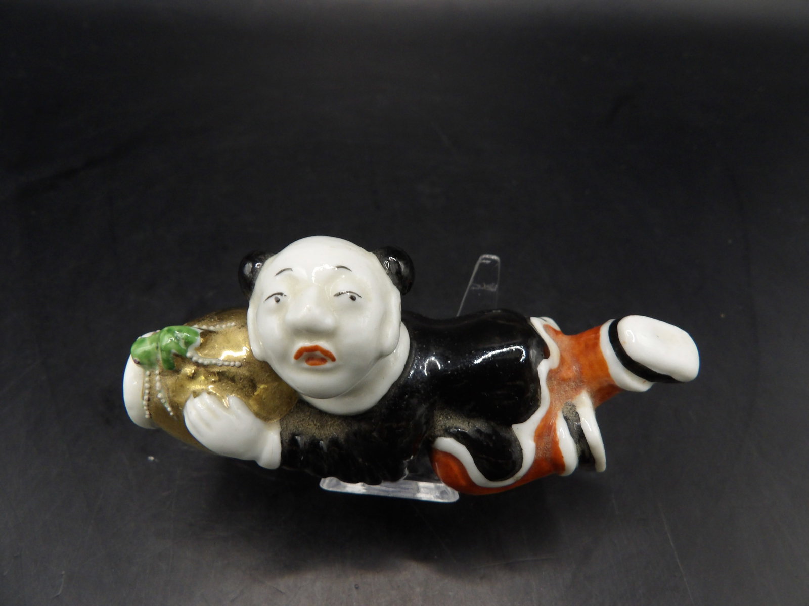 rare antique Chinese molded porcelain snuff bottle depicting a lying man: 2.8 inches length.