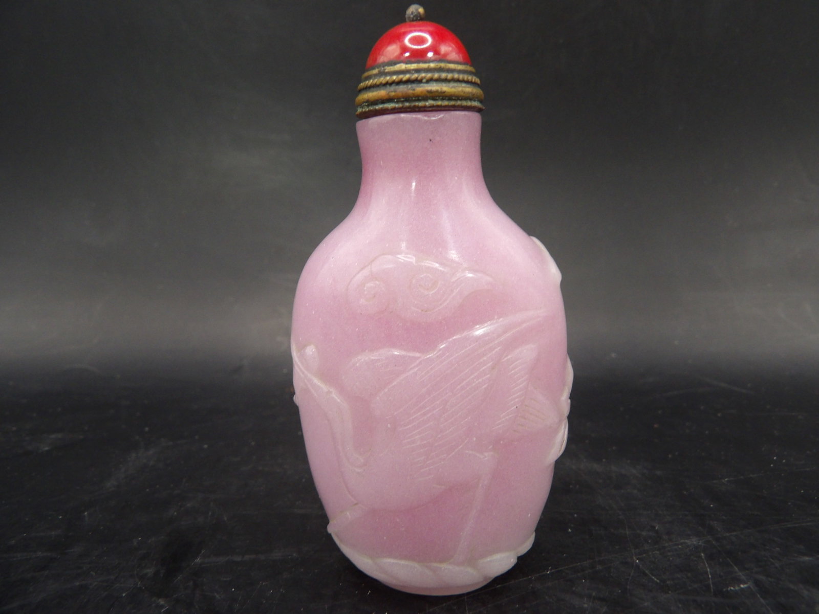 fine Chinese carved pink glass snuff bottle with crane flowers clouds and Qing dynasty Qianlong mark: 3.2 inches height.