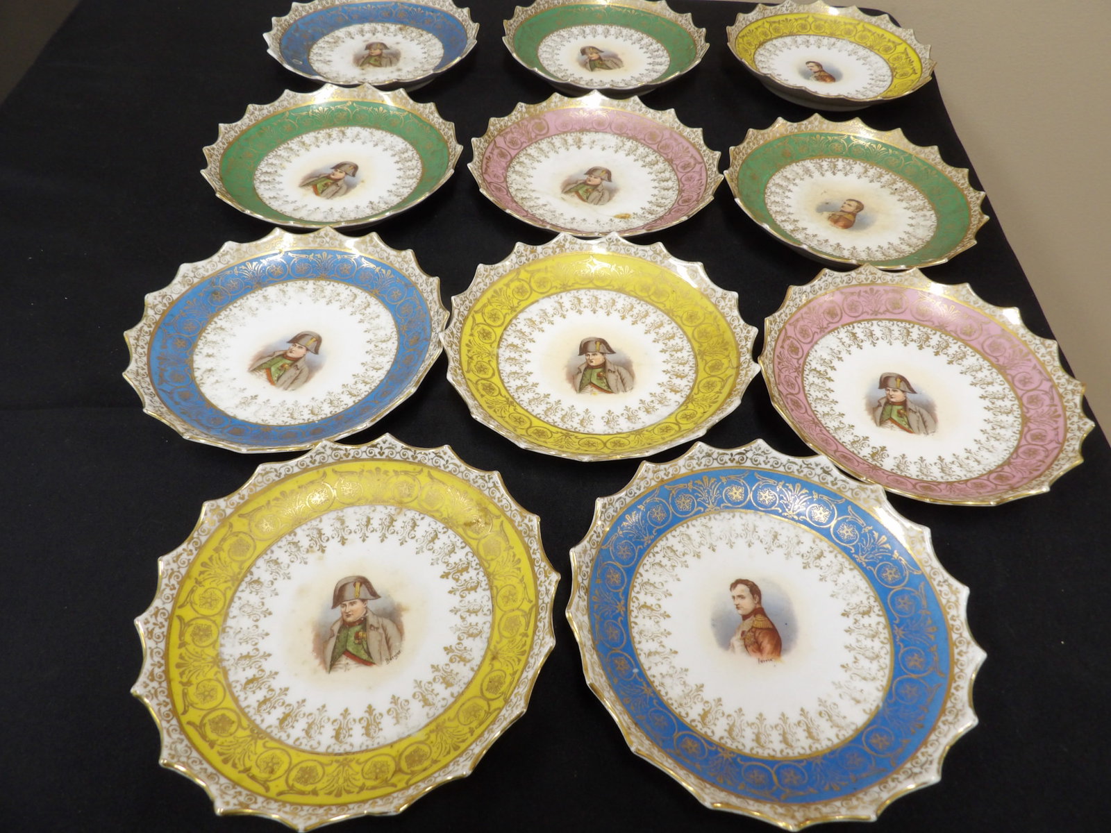 rare lot of 12 antique Austria Victoria plates featuring Napoleon with gilt scalloped edges: 6 inches diameter. Lot of 12.