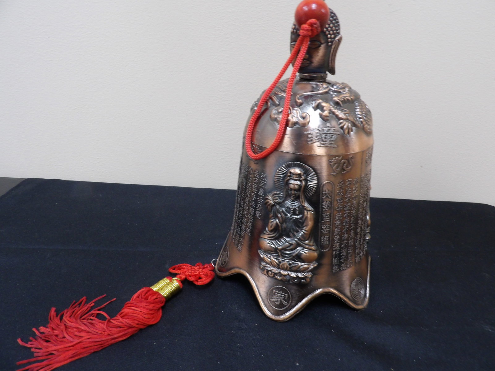 Chinese metal bell featuring embossed buddha with dragon motif and scriptures (1 of 9)
