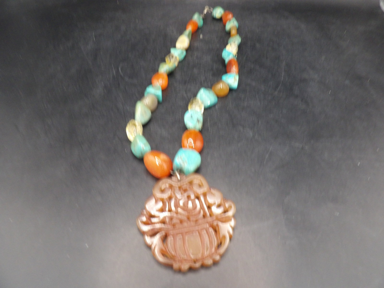 Chinese carved jade pendant with turquoise carnelian and crystal beaded necklace: 2 inches height pendant. 20 inches length necklace.