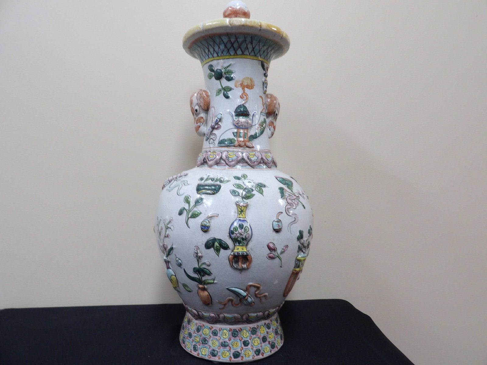 unique Chinese large lidded polychrome enameled porcelain vase with raised motifs and elephant ears: 22 inches height.