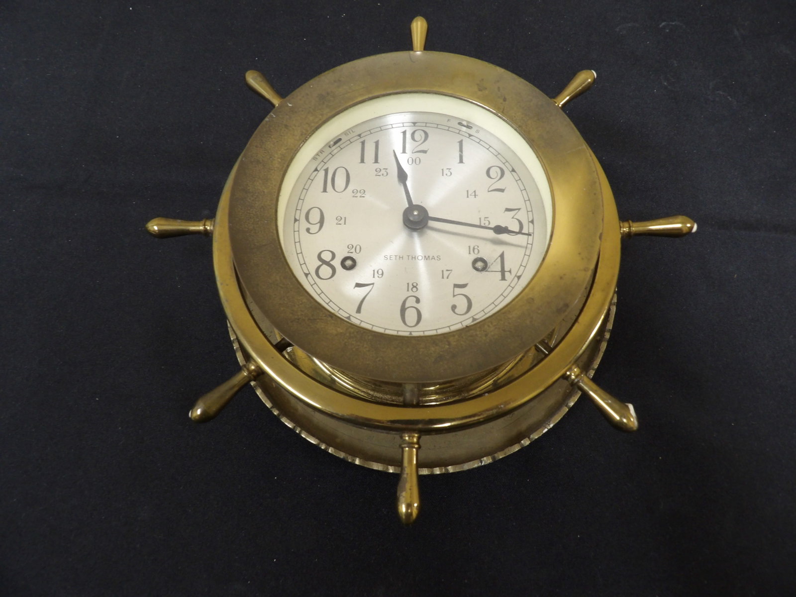 Seth Thomas brass ship's wheel clock with a 24-hour dial: 8.7 inches length. We will inhouse ship items to you very affordable and efficient. Select self-arrange shipping.