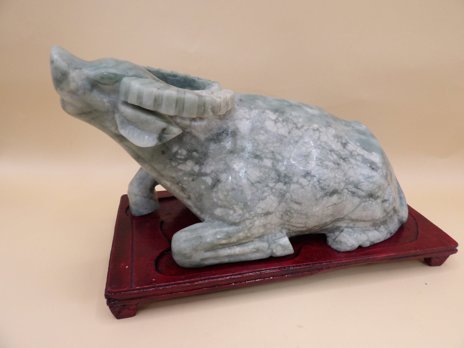 Chinese jade water buffalo statue on wooden base: 7-inch length statue statue is adhered to wooden base. Total weight is 3.9 lbs. We will inhouse ship items to you very affordable and efficient. Select self-arrange shipping.