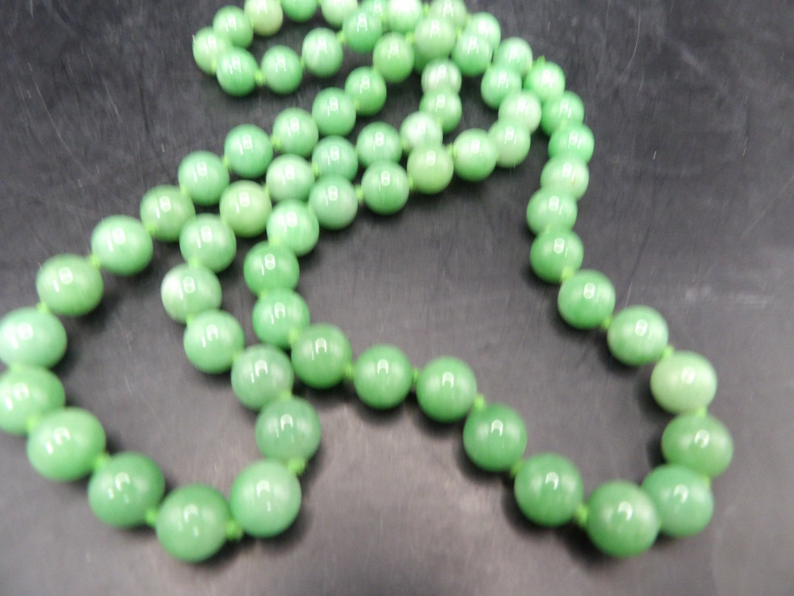 28 inches long Chinese jadeite jade beaded necklace: 75 grams. 28 inches long. We will inhouse ship items to you very affordable and efficient. Select self-arrange shipping.