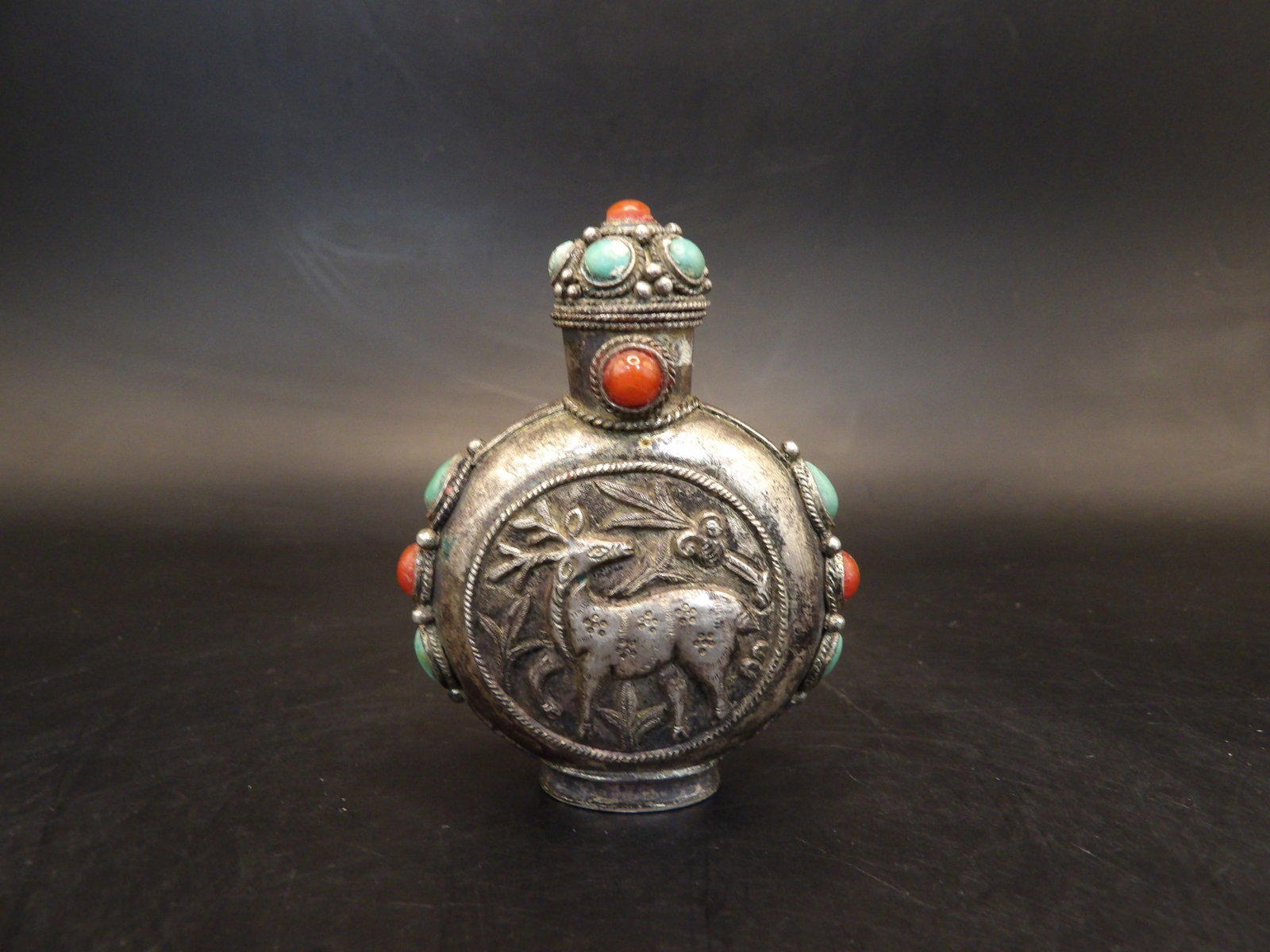 antique Tibetan silver snuff bottle with repousse deer motif and inlaid details: 2.2 inches height.
