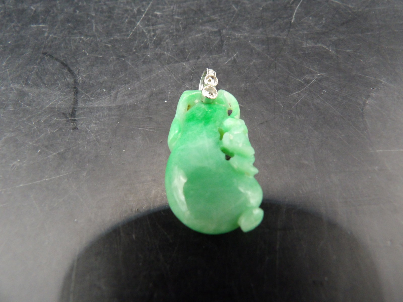 Chinese carved jadeite jade pendant with diamond accents on the bail: 5 grams. 1.3 inches height including diamond accented bail.