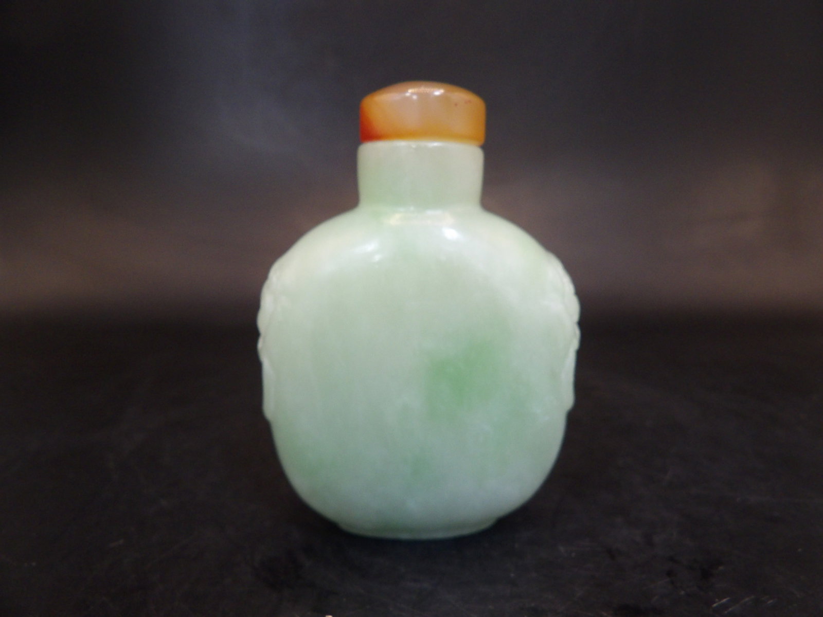 Chinese celadon jade carved snuff bottle with mask handles and agate stopper: 2.6 inches height.