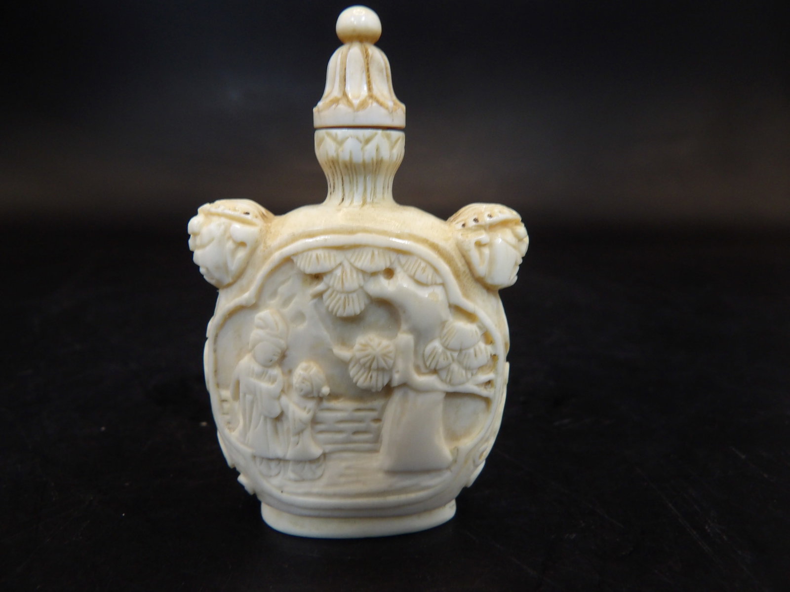 Chinese or Japanese antique carved natural material snuff bottle with mask handles: 2 inches height. No international shipping.