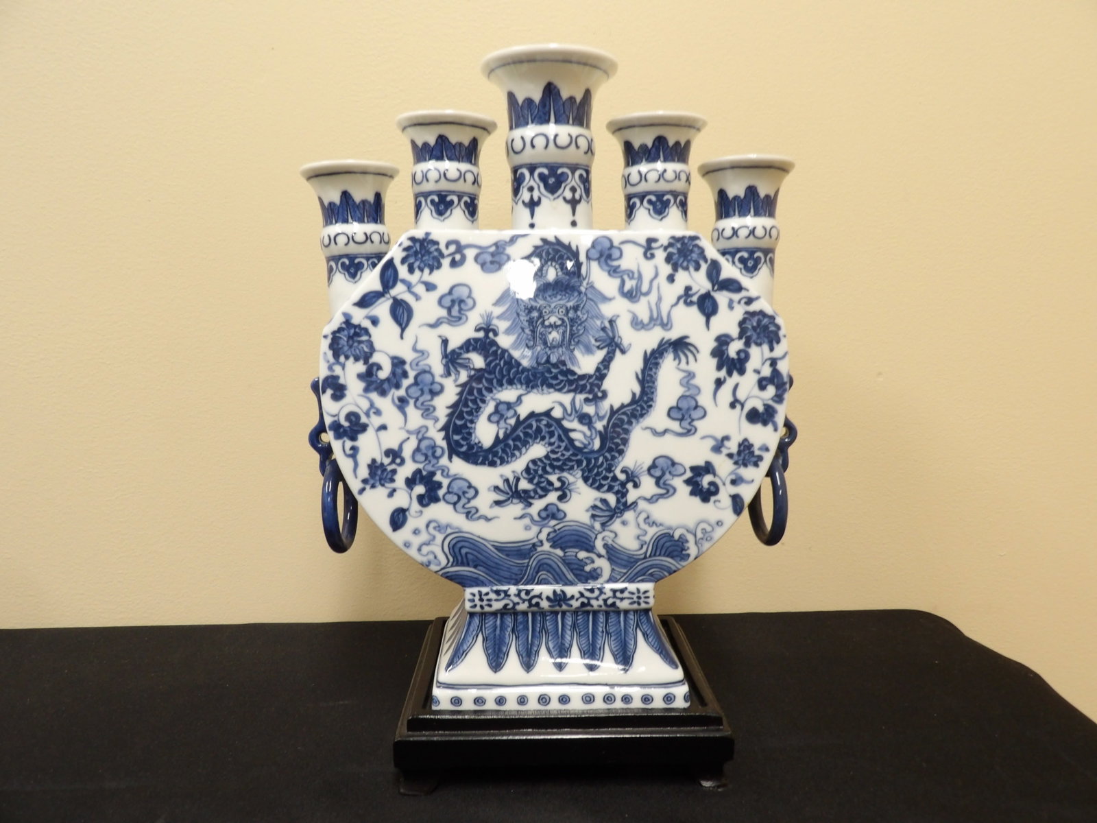 Chinese blue and white five-spouted dragon vase with rings and Qing dynasty Qianlong mark: 13 inches height including wood base.