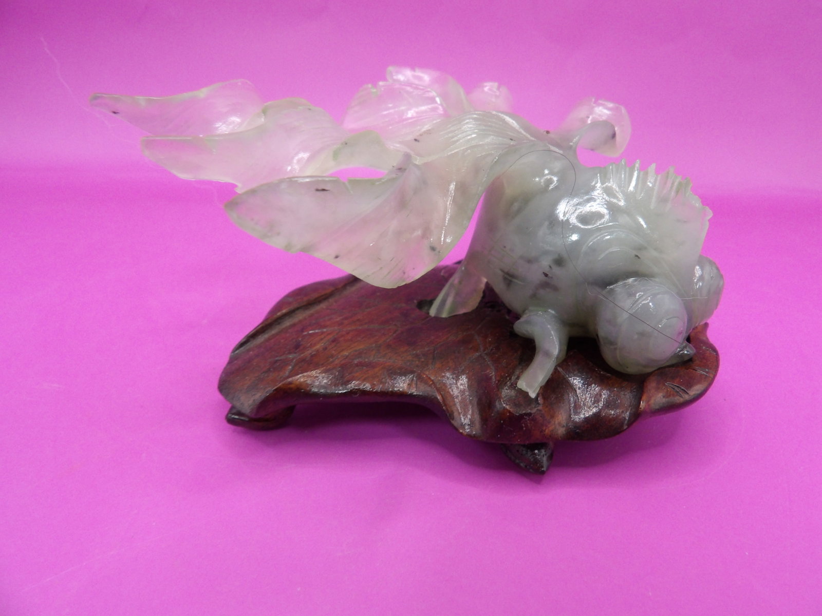 Chinese carved jade goldfish figurine on a custom carved lotus shaped wood base: Approx. 4 inches length.