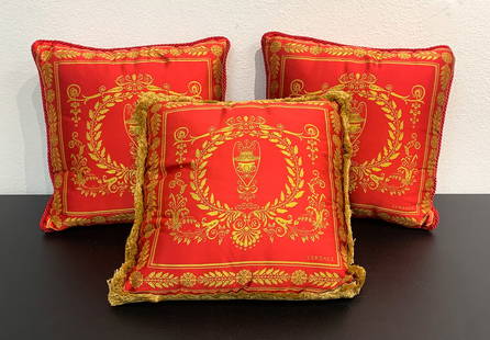 Three Versace Red And Gold Silk Pillows: Three Versace Red And Gold Silk Pillows. Each With Anthemion And Vase, Two With Cord Edge, One Fringe Edge, 16 X 16 Inches, With Tags And Dust Covers. See Photos For Condition Including One Piece Of