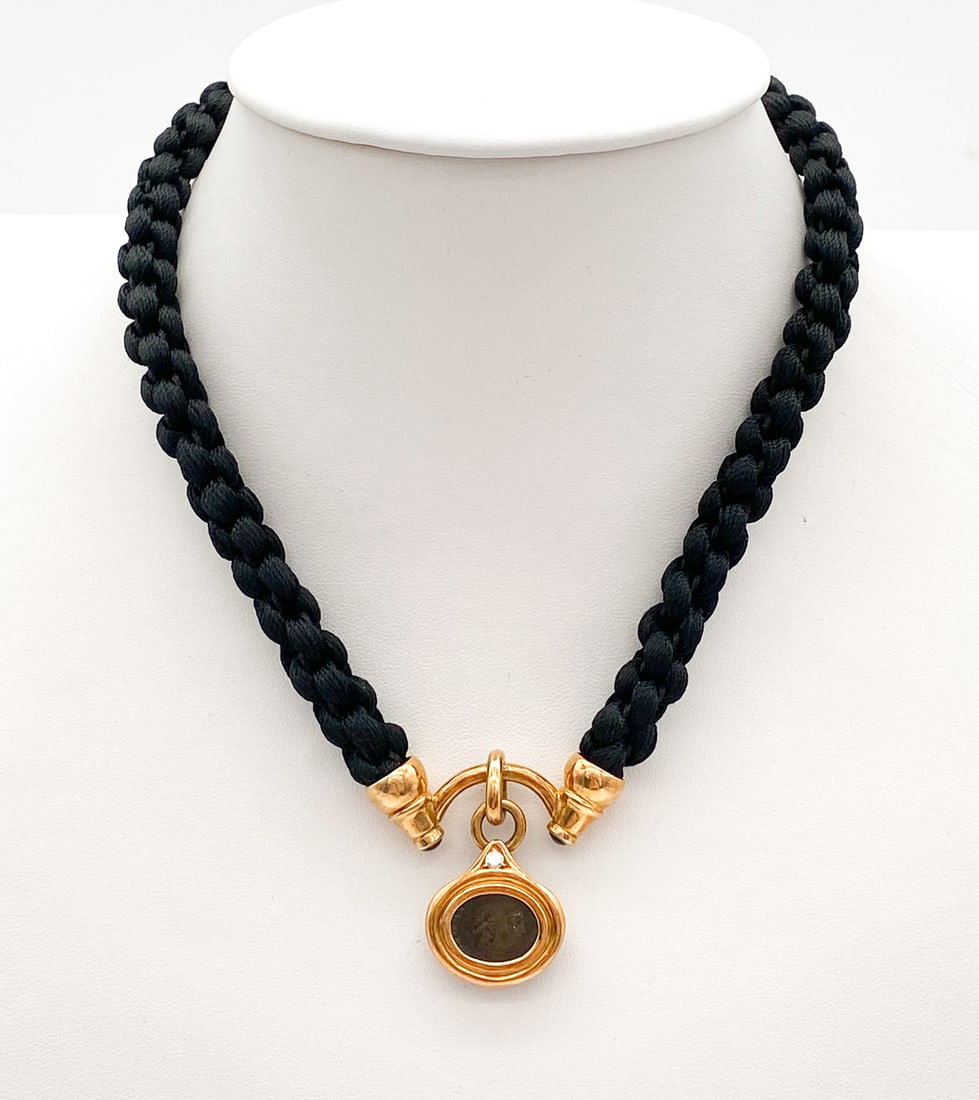 Ancient Coin, 18k Yellow Gold & Diamond Necklace: Ancient Coin, 18k Yellow Gold & Diamond Necklace With Diamond Accent. 15 Inches, Pendant Approx 1 Inch, 31.46dwt. Braided Cord And 18k Clasp.
