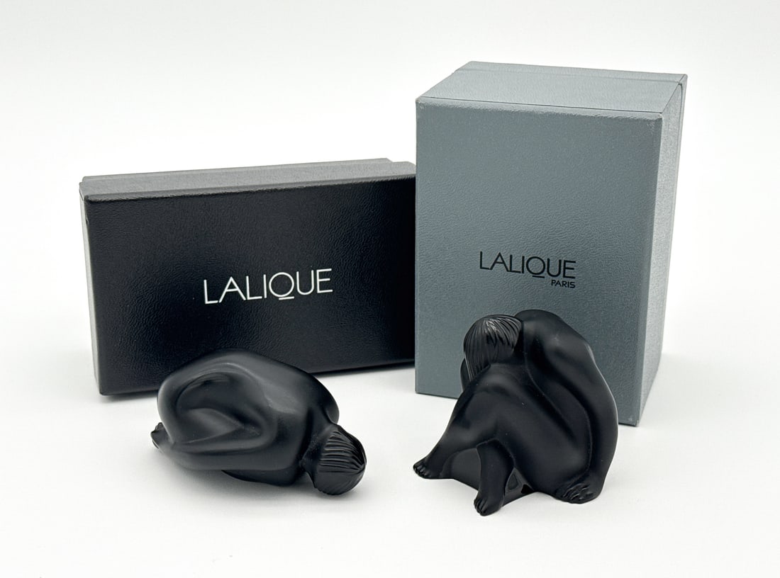 Lalique Nu Feuille Pliee & Nu Assis Noir Figures: Lalique Nu Feuille Pliee & Nu Assis Noir Figures, French, After 1945, Each Nude Woman In Black Glass Marked Lalique France, With Original Boxes, One With Label 1191800, 2.5 X 2.5 X 2 Inches, No Chips 