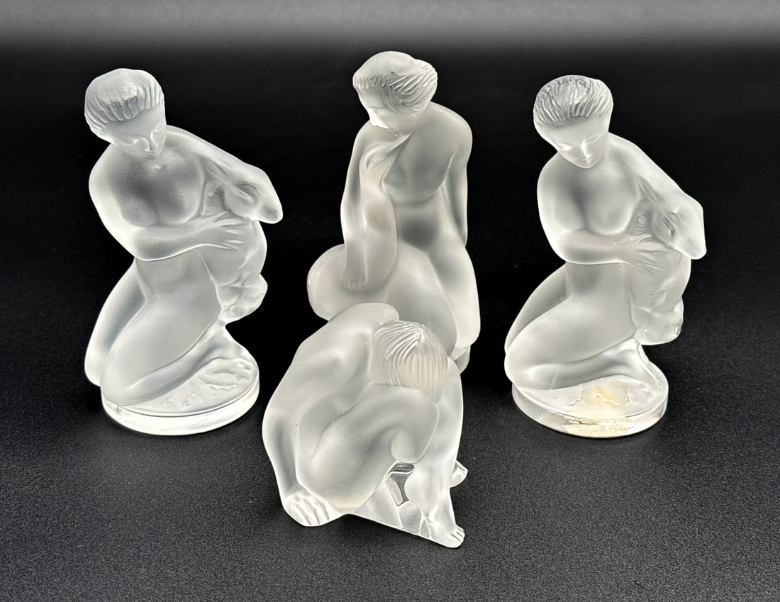 Four Lalique Glass Nude Figures: Four Lalique Glass Nude Figures, French, After 1945, Two Diana With Faun, One Leda With Swan, One Nu Assis Seated, All Frosted Crystal Marked Lalique France, Diana With Made In France Paper Label Unde