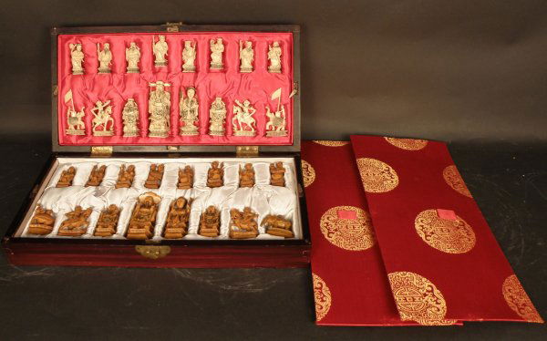 Chinese Ivory Chess Set: Comprised of thirty-two pieces carved to show various Chinese subject, wooden box. Largest 4 in. 18x19" Box. One piece has been repaired.