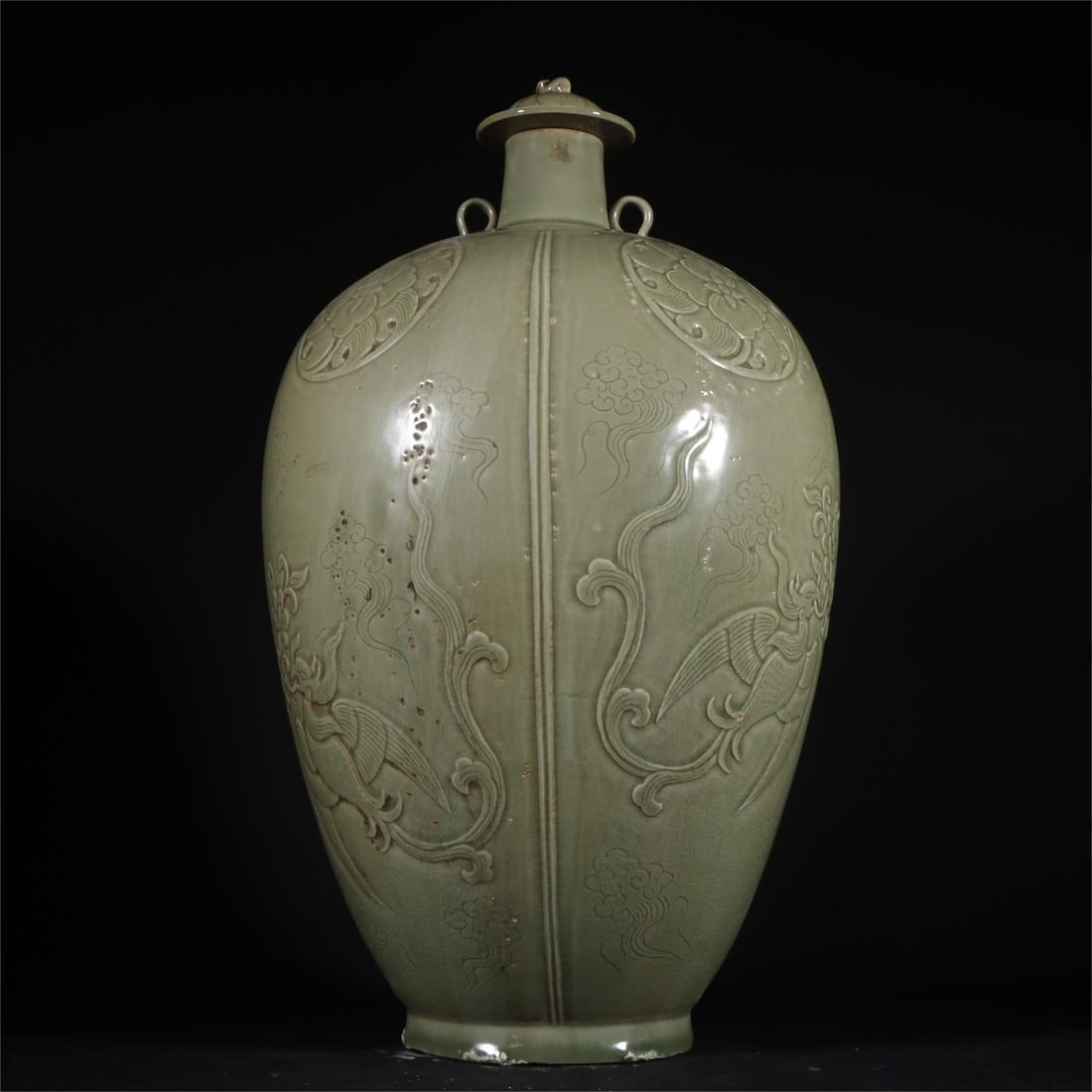 A secret color celadon high-relief phoenix pattern bottle with lid from the Yue kiln in the Tang: The secret color celadon high-relief phoenix pattern bottle with lid of the Yue kiln in the Tang Dynasty H:38cm W:22cm (The Dimensions Of All Batches Are Manually Measured.If You Need More Detailed In