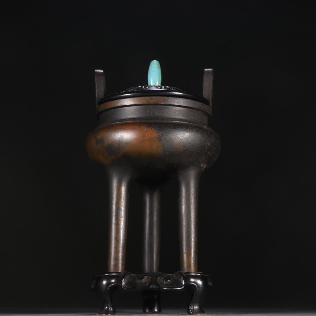 A three-legged aroma burner with copper tires facing the sky (1 of 9)