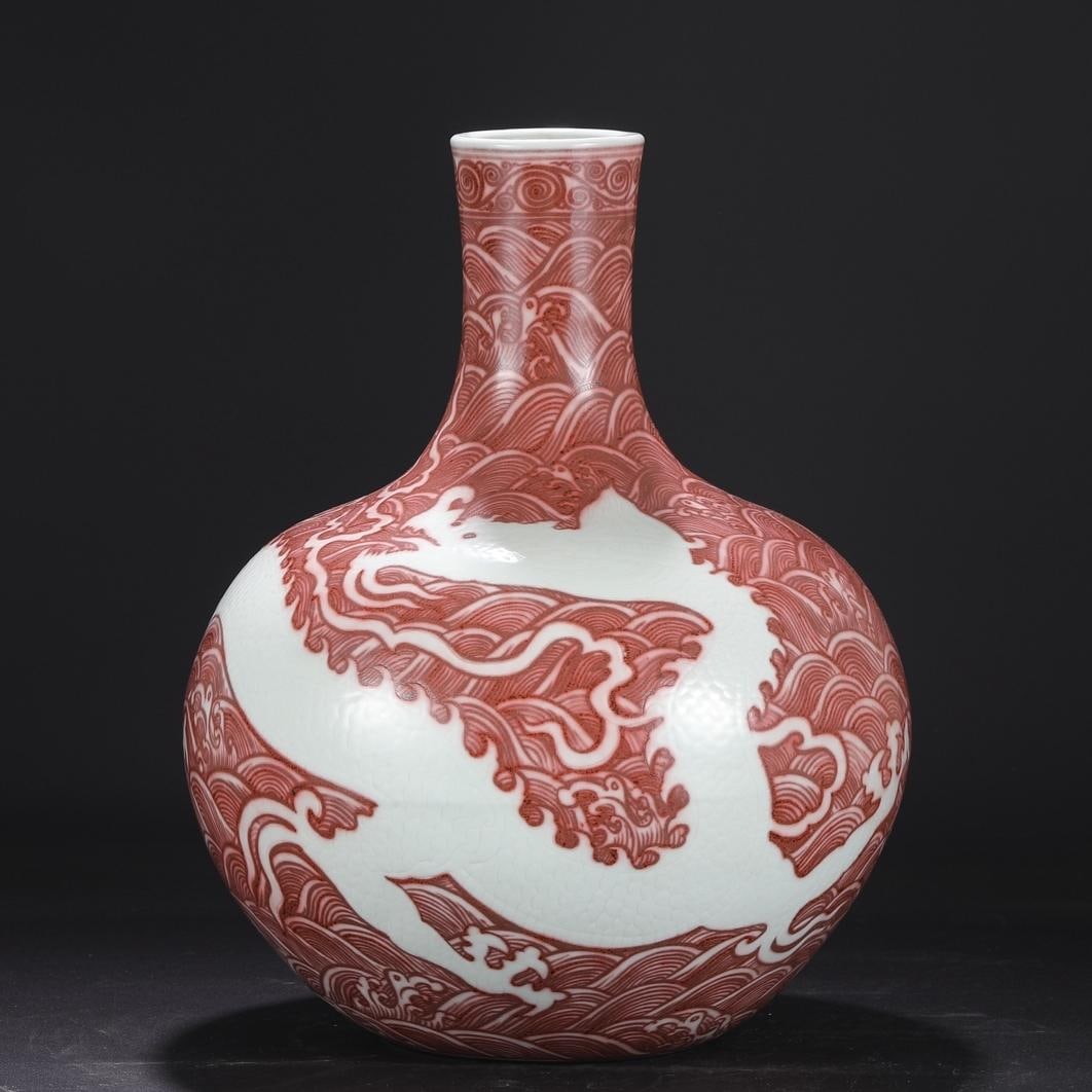 A glazed red white carved seawater dragon pattern large sky ball vase made in the Yongle year of the: The glazed red white carved seawater dragon pattern large sky ball bottle made in the Yongle year of the Ming Dynasty Size:H:42cmCalibre8.5cmBellydiameter30.5cm (The Dimensions Of