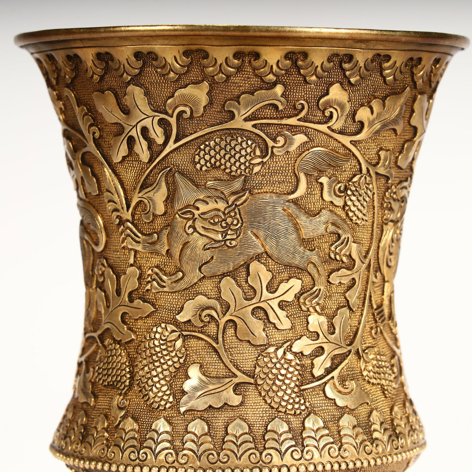 A fine copper-gilt grape-patterned goblet. - 9